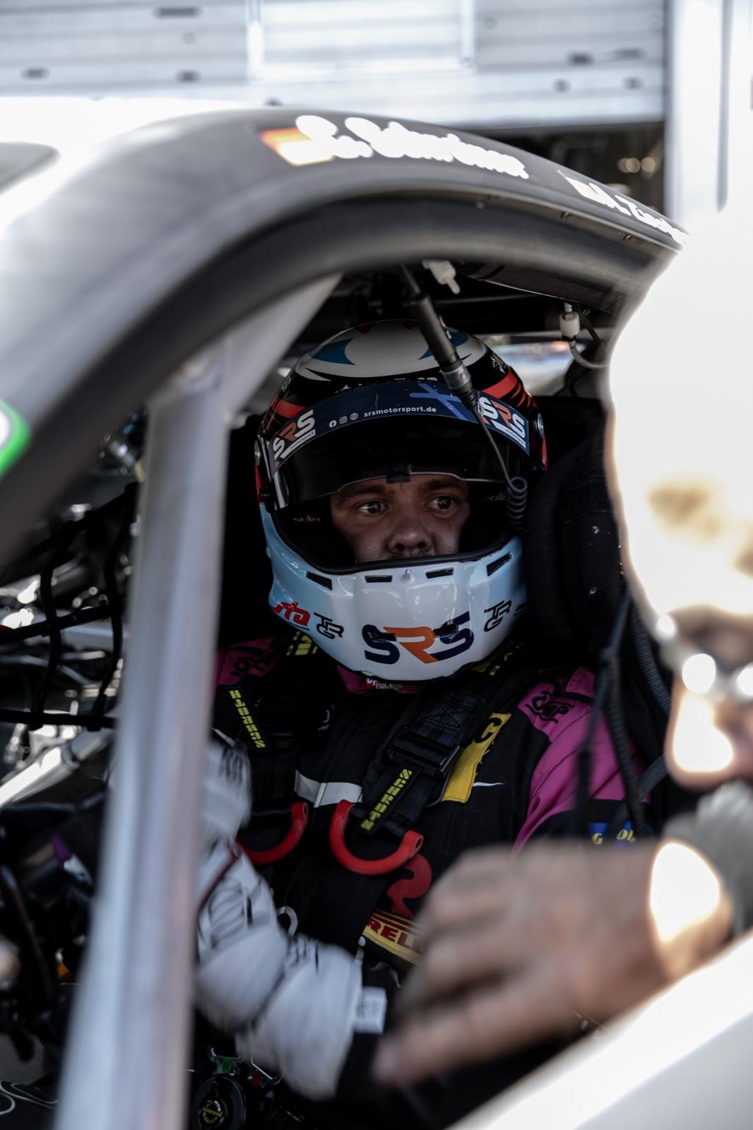 Driver strapped into the GT3 cockpit, looking out of the window
