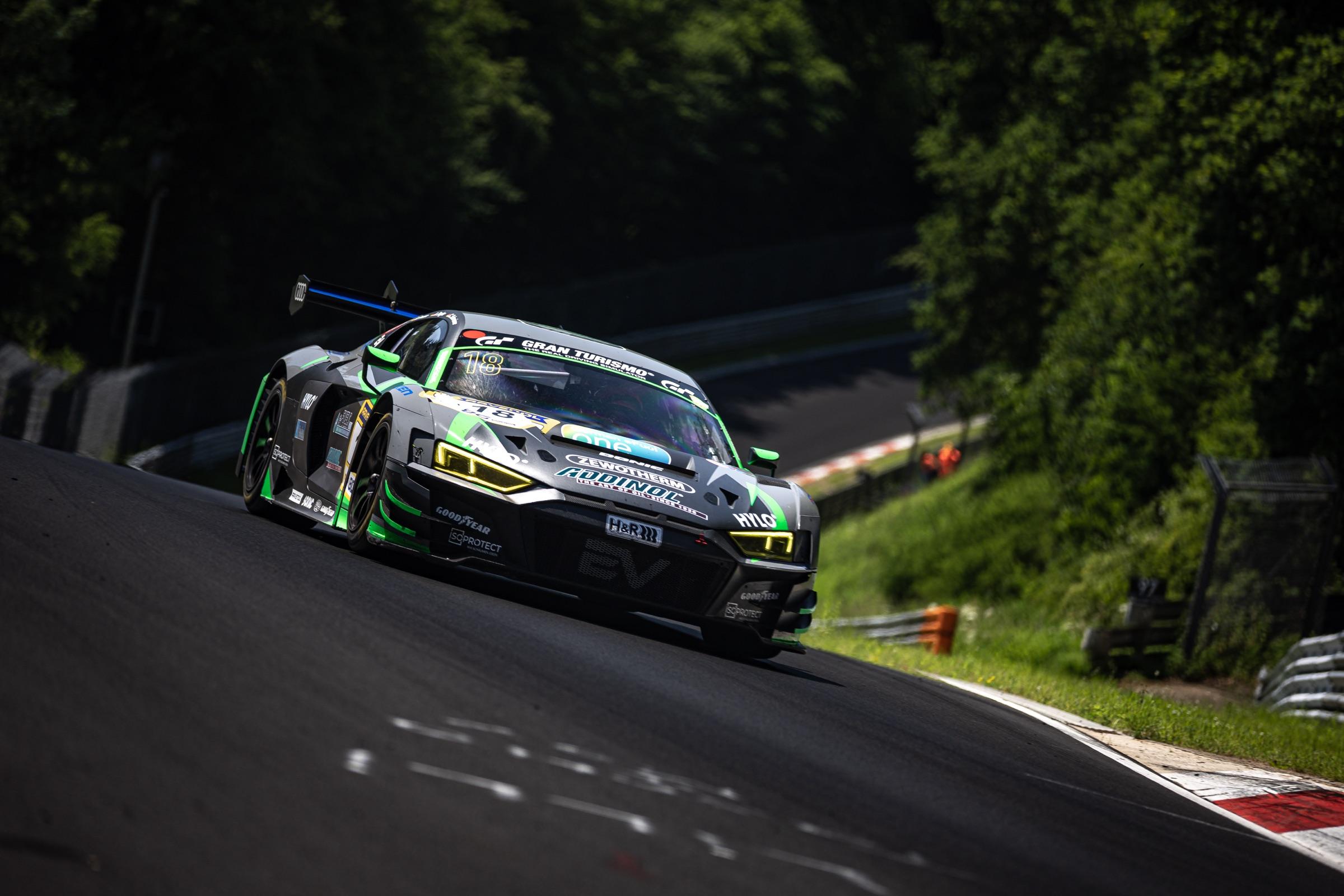 Audi R8 LMS GT3 number 18 cresting a rise on the Nordschleife